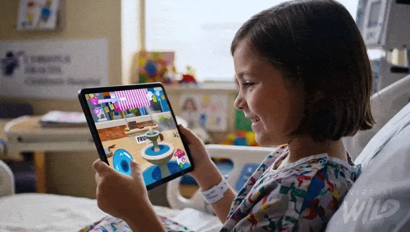 Young patient using the CHRISTUS game on a tablet