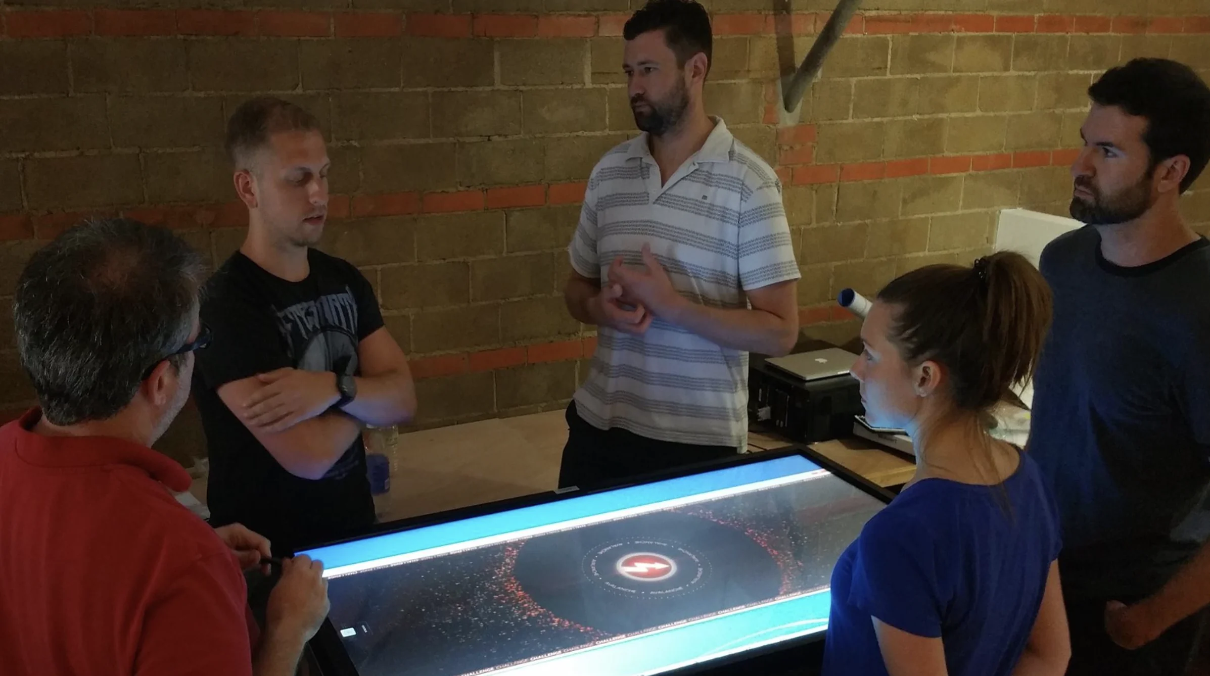 Project team collaborating around the HPE interactive touch table