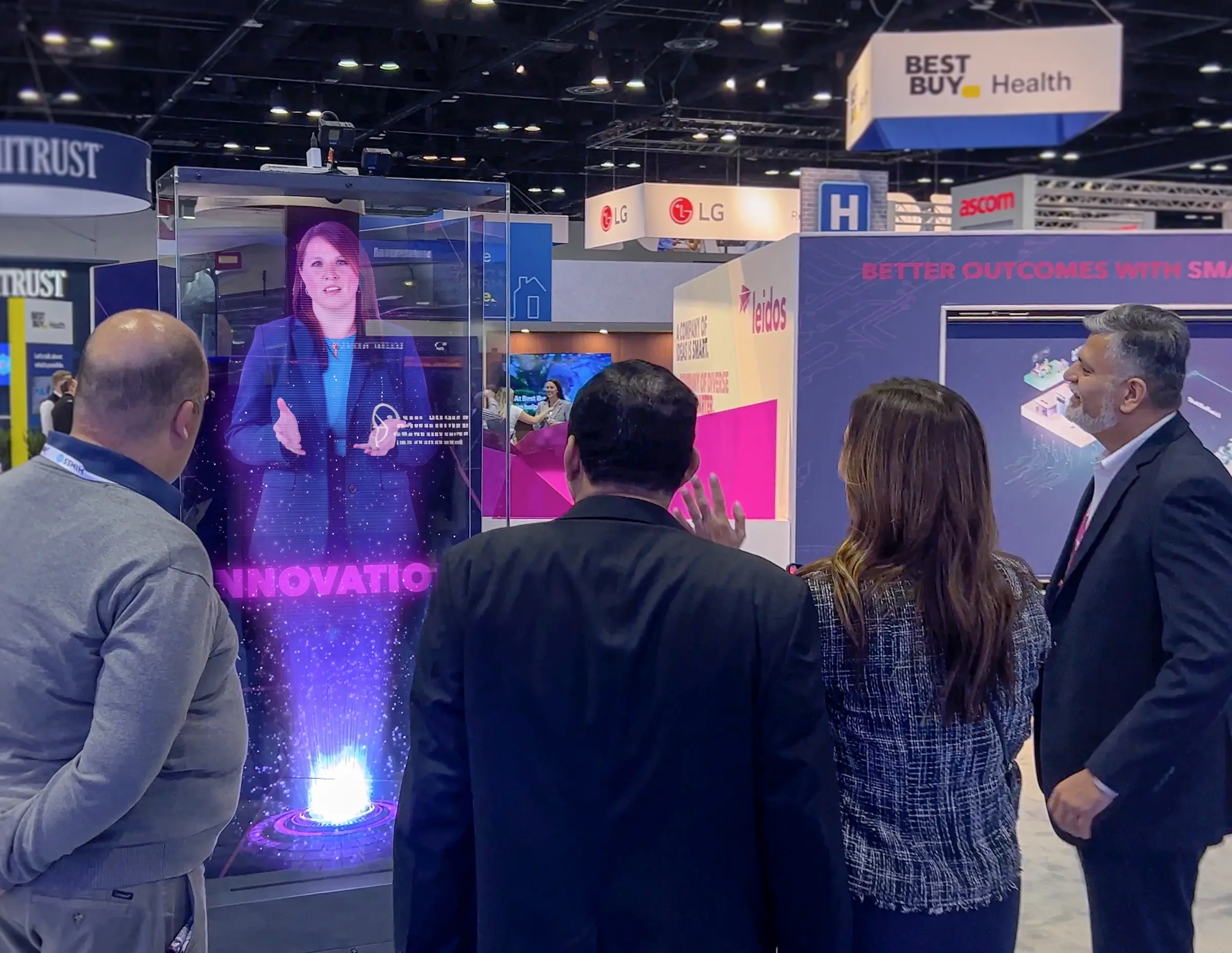 Visitors gathered around the Leidos digital-health hologram