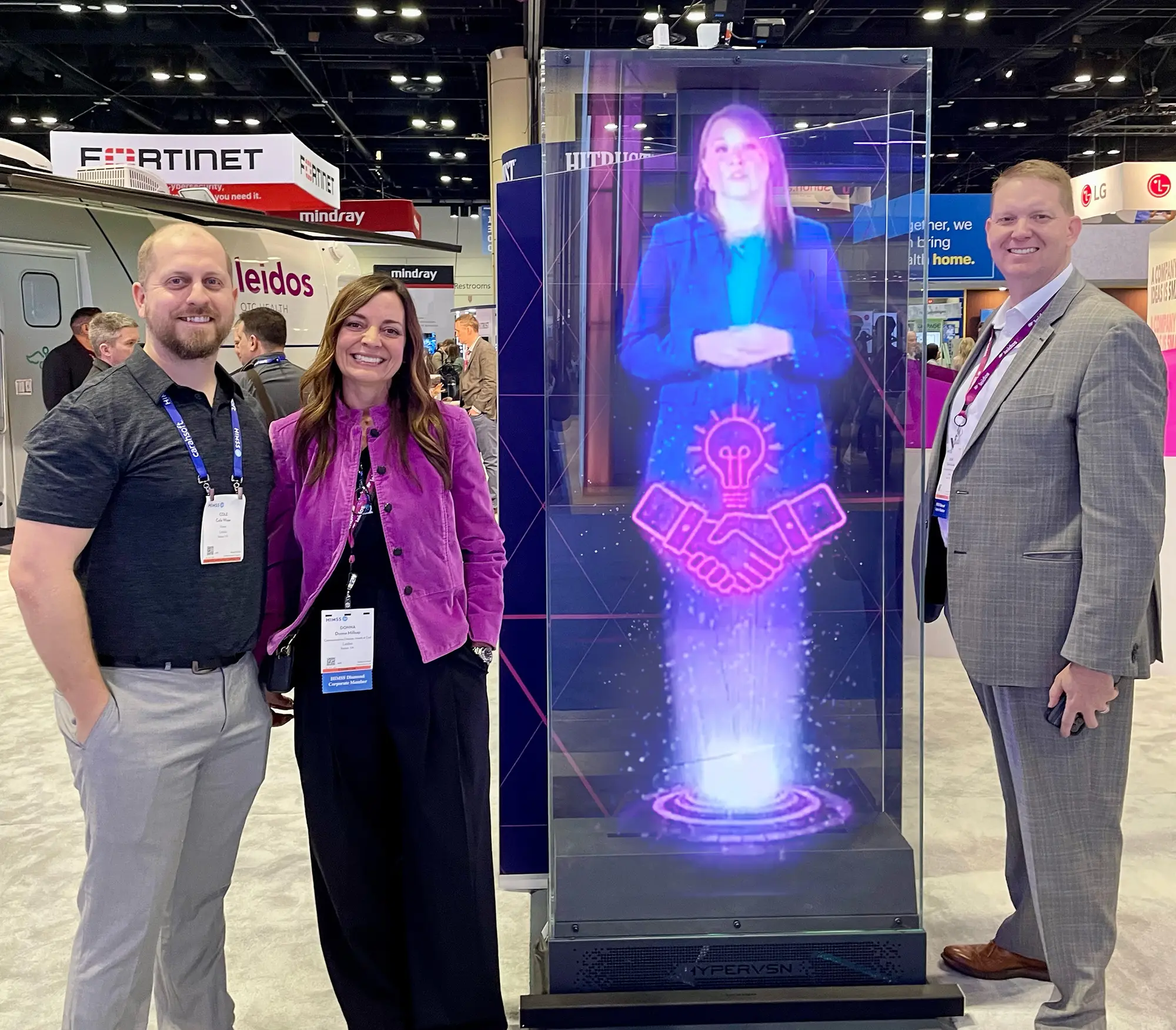 Leidos Health team beside the digital hologram experience